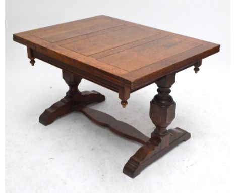 An early 20th century oak drawleaf table with rectangular top, 91 x 121cm, on two ring turned columns and bracket feet united