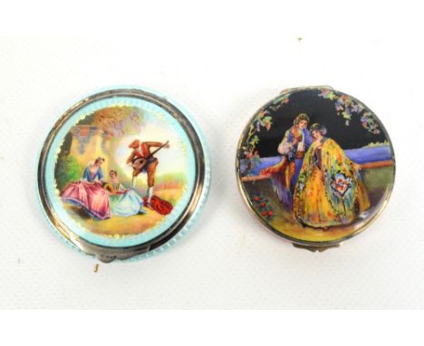 Two early 20th century silver and enamel circular patch boxes, the first with central panel depicting a musician and two fema