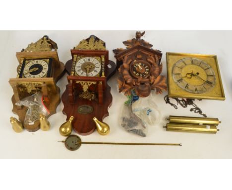 Four modern decorative wall clocks including a cuckoo clock, a square dialled example, and two others (4).