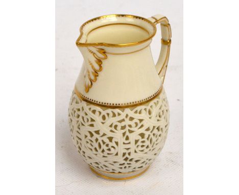 A George Owen Royal Worcester ivory porcelain reticulated double walled cream jug of baluster form with gilt heightened edges