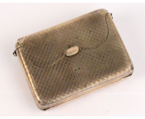 A George V hallmarked silver purse of rectangular form with engine turned decoration, centred with a circular cartouche initi