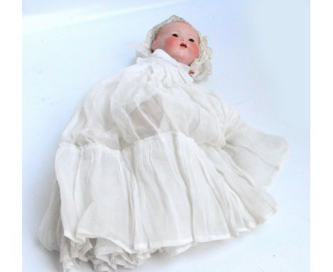 An early 20th century Armand Marseille bisque headed doll stamped "AM Germany 351./5.K.", with open mouth and two teeth, eyes