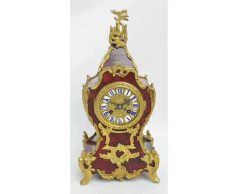 A late 19th century French faux tortoiseshell and gilt metal mounted eight day mantel clock with rococo scrolling case and mo