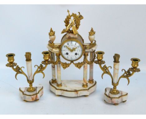 A late 19th century French marble gilt metal mounted three piece clock garniture, the eight day clock surmounted by a bow and