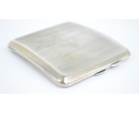 A George V hallmarked silver cigarette case of rounded rectangular and curved form with overall engine turned decoration, SJ 
