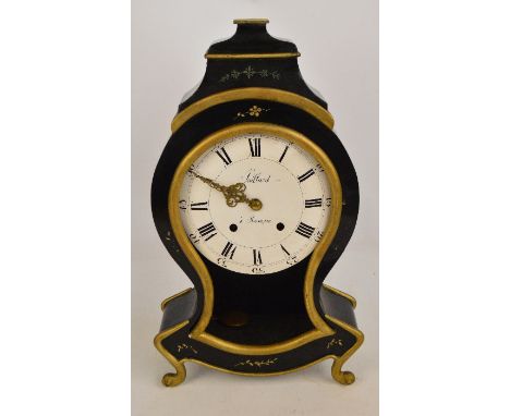 A 19th century French mantel clock of shaped form with black lacquer and floral decoration and gilded wood trimming with shap