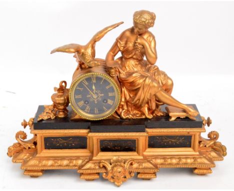 A late 19th century gilt spelter figural mantel clock with drum type eight day movement, the dial set with Roman numerals abo