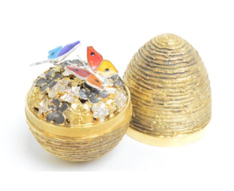 STUART DEVLIN; an unboxed limited edition hallmarked silver and silver gilt surprise egg, the ribbed textured body enclosing 