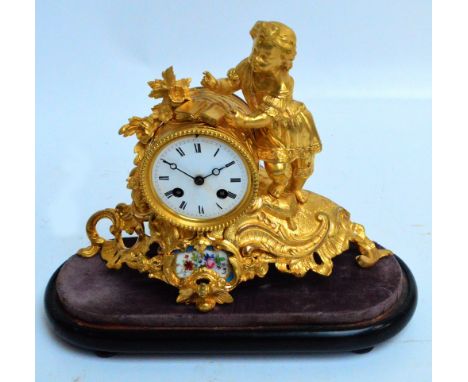 A late 19th century French gilt metal figural mantel clock with drum type eight day Japy movement with white enamel dial set 
