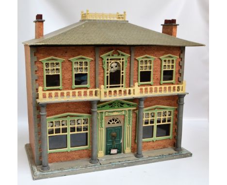 A Victorian timber doll's house with two section hinged front with columns, balcony and ornamental doors and windows enclosin