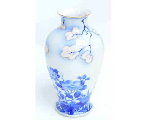 A Japanese Meiji period porcelain Fukagawa vase of baluster form painted in underglaze blue with floral motifs and blossoming