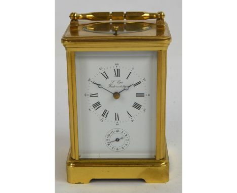 An early 20th century French brass repeater carriage clock, the rectangular enamel dial set with circular chapter ring and su