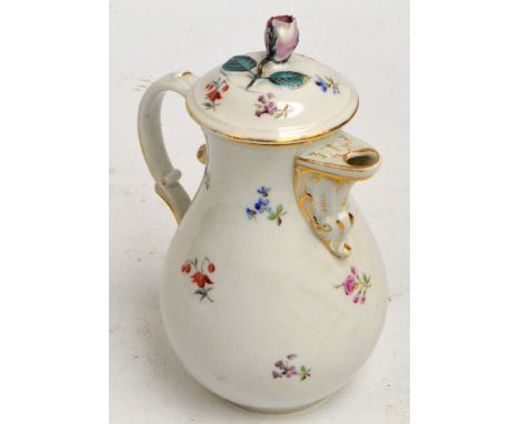 A 19th century porcelain hot water jug of baluster form hand painted with floral sprays, with gilt heightened spout and cover