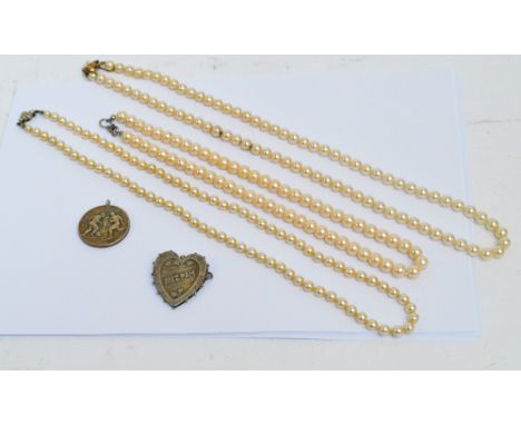 A cased Majorica simulated pearl necklace with a silver gilt clasp, length 62cm and two further simulated pearl necklaces, a 