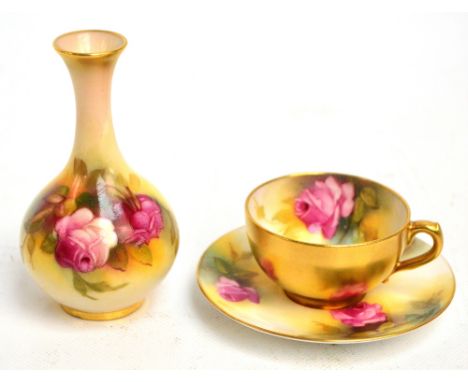 A Royal Worcester hand painted rose decorated cabinet cup and saucer, saucer diameter 9.5cm, and a similar small vase signed 