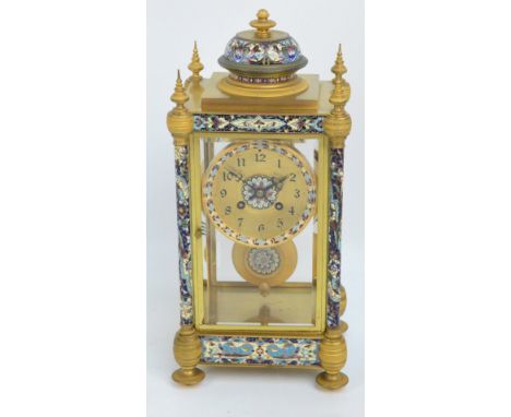 A late 19th century French gilt metal and champlevé enamel decorated four glass mantel clock, the convex dial set with Arabic