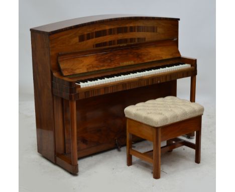 An Art Deco walnut and leopard veneer crossbanded overstrung upright piano by Danemann, the domed case with turned front pill