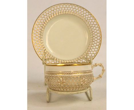 A c.1840s Chamberlain's Worcester porcelain gilt heightened cup and saucer, the double walled reticulated cup with bamboo eff