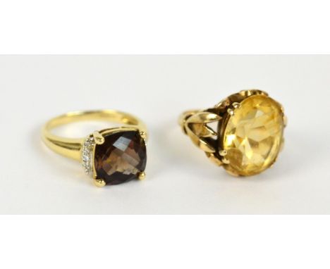 A 9ct yellow gold dress ring set with a large oval faceted citrine with scroll decorated setting, size K and a further gold d