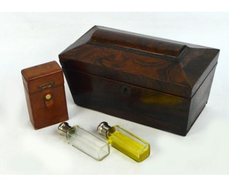 A Victorian rosewood tea caddy of sarcophagus form, length 27.5cm (af), and a pair of leather cased clear glass chrome plated
