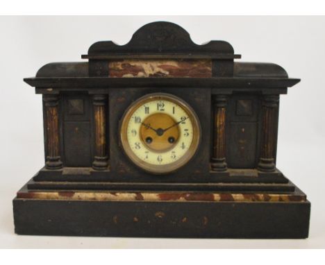 A large Victorian slate and pink marble detailed eight day mantel clock, the circular dial set with Arabic numerals, with flo