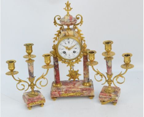 A late 19th century French marble and gilt metal mounted three piece clock garniture, the central eight day Japy Freres clock