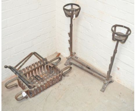 A wrought iron fire grate and a pair of andirons.