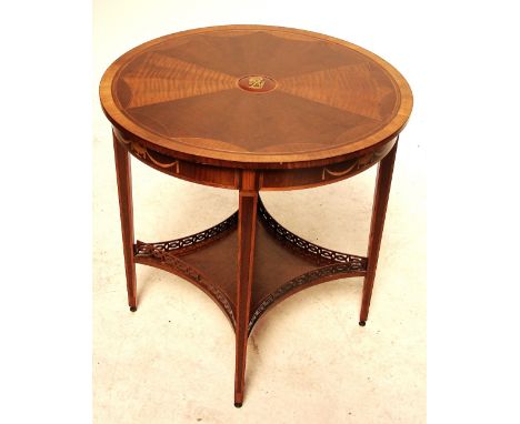 A reproduction mahogany rosewood crossbanded and string inlaid two tier occasional table with unusual raised central panel de