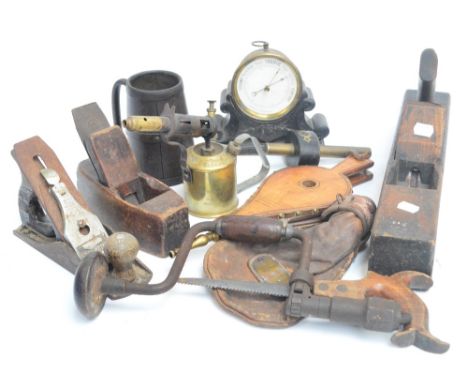 A quantity of predominantly 19th century tools to include planes, a saw, also a Swedish brass blow lamp, a pair of bellows, a