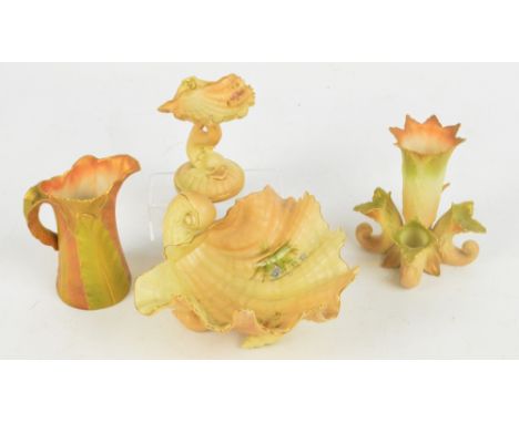 Four pieces of Royal Worcester blush ivory items comprising a small scallop shaped dish with stem modelled as a dolphin, a sh