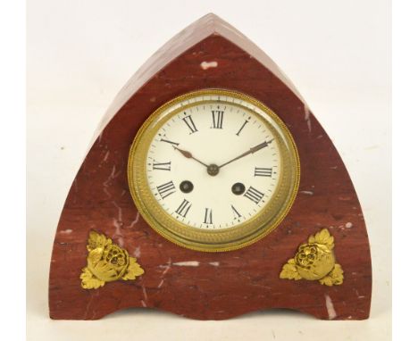 An early 20th century arched marble mantel clock with white enamel dial set with Roman numerals housing an eight day movement