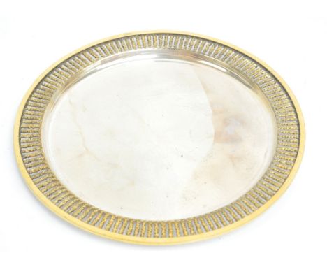 STUART DEVLIN; a boxed silver and silver gilt circular plate, with pierced rim and dimpled recessed main panel, London 1974, 