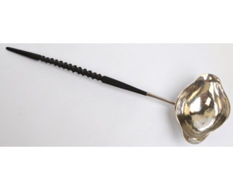 A George II hallmarked silver toddy ladle with oval twin lipped bowl with tapering stem and wrythen wooden handle, initialled