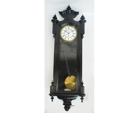 An ebonised Vienna style single weight wall clock with white enamel dial set with Roman numerals, length 108cm. CONDITION REP