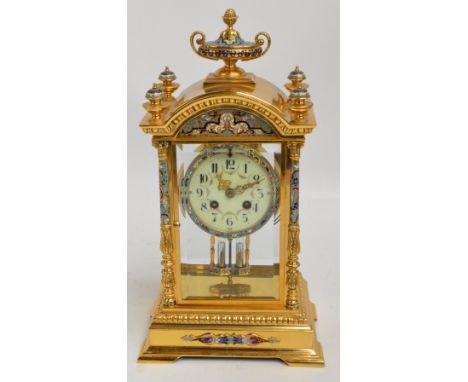 A 19th century French gilt brass and champlevé enamel decorated four glass eight day mantel clock, the circular enamel dial s