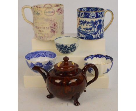 A 19th century blue and white ceramic mug transfer decorated with a continuous architectural landscape, centred with hand pai