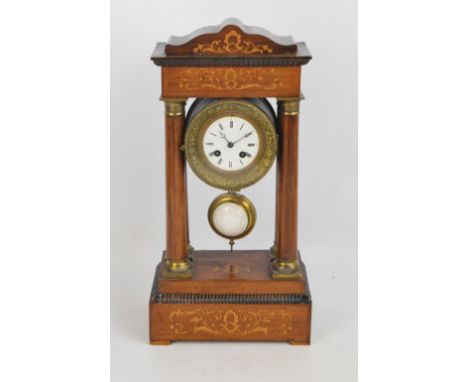 A late Victorian rosewood and inlaid eight day Portico clock, the circular enamel dial set with Roman numerals raised on four