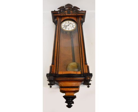 A late 19th century walnut and ebonised twin weight Vienna style wall clock, the white enamel dial inscribed "J. Stadler, Sal