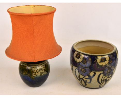 A Royal Doulton Lambeth jardinière decorated with flowerheads and stylised foliate motifs on a grey ground, height 19.5cm and