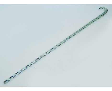 A glass walking stick with black and white internal twist decoration, length 98cm. CONDITION REPORT: Chips to the bottom of t
