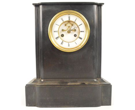 A late 19th century French black slate mantel clock with white enamel dial set with Roman numerals and with visible escapemen