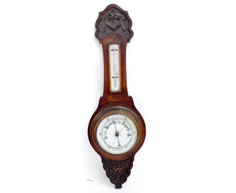 An early 20th century stained banjo aneroid barometer/thermometer with carved top and bottom, height 73cm.