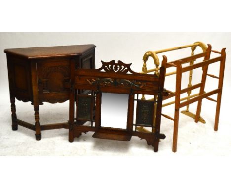 An Art Nouveau oak wall mounted hall coat rack centred with a rectangular mirror flanked by two copper floral panels, with si