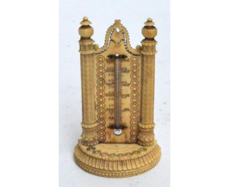 A 19th century finely carved ivory thermometer flanked by two decorative columns on semi-circular base, height 9.5cm (af).