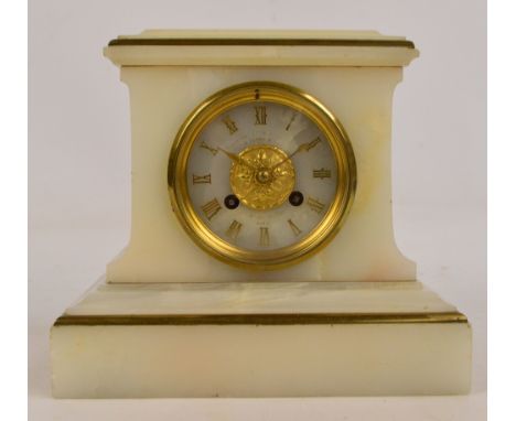 A French white onyx and gilt metal detailed mantel clock, the circular dial set with applied Roman numerals and maker's name 