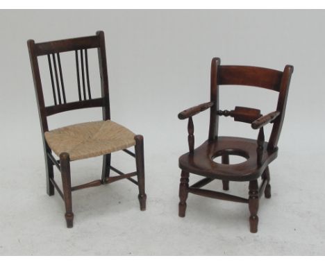 A child's ash and elm open arm commode elbow chair on turned stretchered supports and a child's rush seated spindle back side