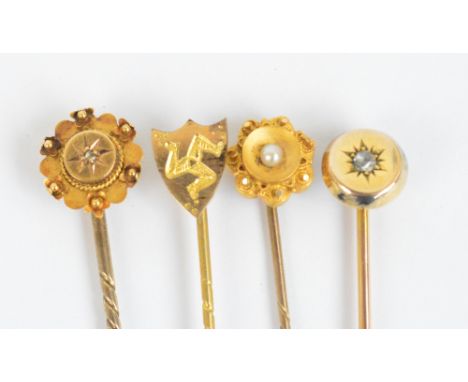 A group of four tie pins including two set with diamonds and one with seed cultured pearl, two stamped 15ct (4).