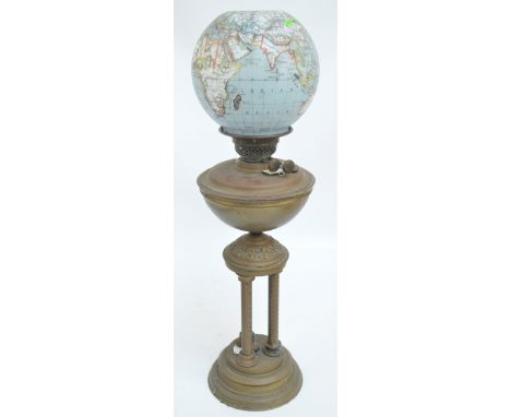 A Victorian oil lamp with brass reservoir raised on three columns above circular stepped base, with rare transfer decorated a