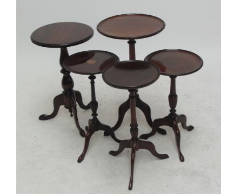 Five reproduction mahogany tripod occasional tables, one with inlaid central panel.