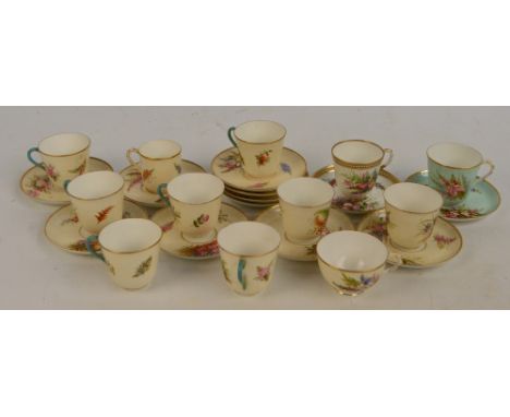 A group of Royal Worcester porcelain predominantly cream glazed hand painted floral cups and saucers with gilt heightened rim